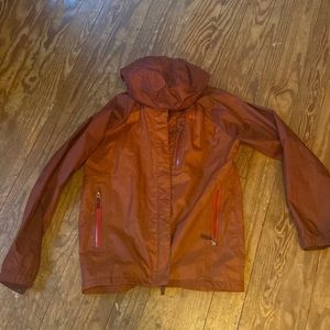 REI classic rain/ wind coat Hooded. 3 front pockets. Kid staple.